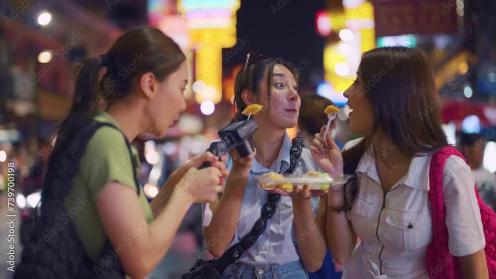 Asian young women friend record vlog while travel outdoor in the city.