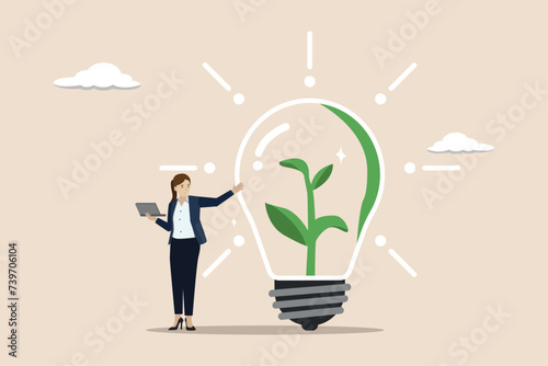 Environmental care in office, social responsibility strategy, ESG concept, businesswoman working with computer on green sustainable lightbulb.