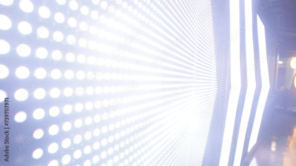 A close up shot of an illuminated LED sign board pointing in the direction with an arrow to the right