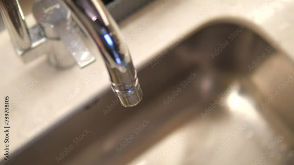 water pouring from a faucet tap slow motion water pouring from a faucet tap slow motion