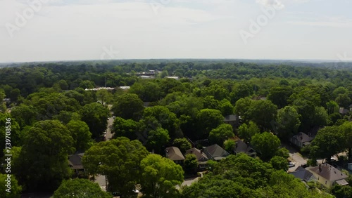 Green Trees and american homes in suburb area of Atlanta City. Sunny day with american neighborhood in park. Aerial birds eye shot. photo