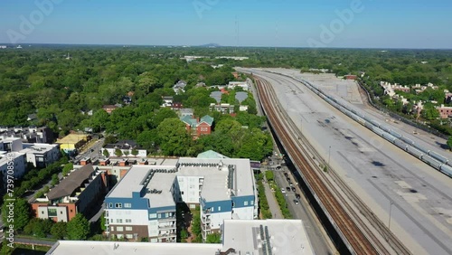 American Neighborhood beside railroad with parking train in suburb of Atlanta City,USA. Sunlight with blue sky in scenic area. Aerial birds eye shot.