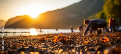 A detailed scene of individuals diligently removing litter from a beach, focusing on the close up view of their dedicated efforts.