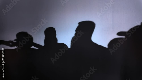 Silhouetted Crowd at Sunset: A romantic scene of love and excitement, as people gather under the evening sky, captured in a striking silhouette against the setting sun