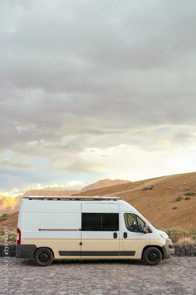 Vertical view of White Van Parked in Desert