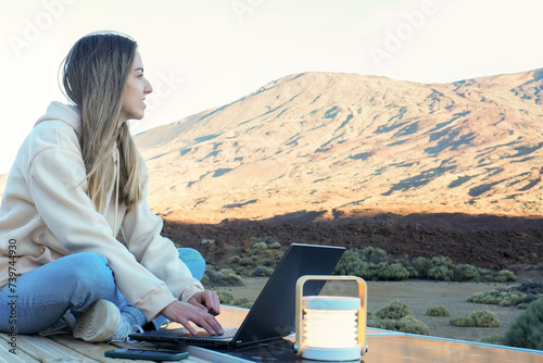 Woman Sitting on Table With Laptop in Front of Teide Mountain