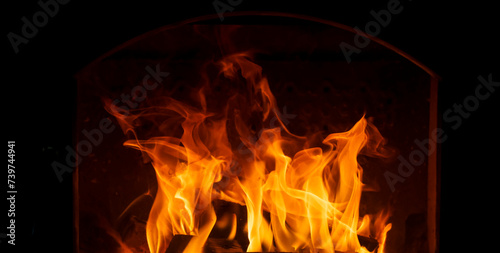 Fire in a stove or fireplace on a dark background isolate