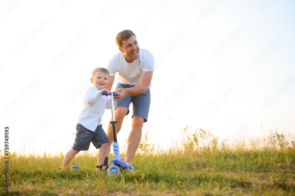 Father's day. Happy family father and toddler son playing and laughing on nature at sunset Father's day. Happy family father and toddler son playing and laughing on nature at sunset