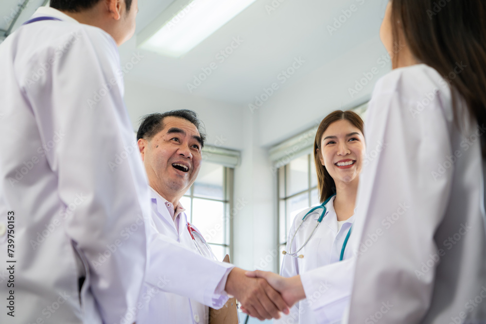 A delighted doctor team enjoying achievement in a hospital setting with high five. A delighted doctor team enjoying achievement in a hospital setting with high five.