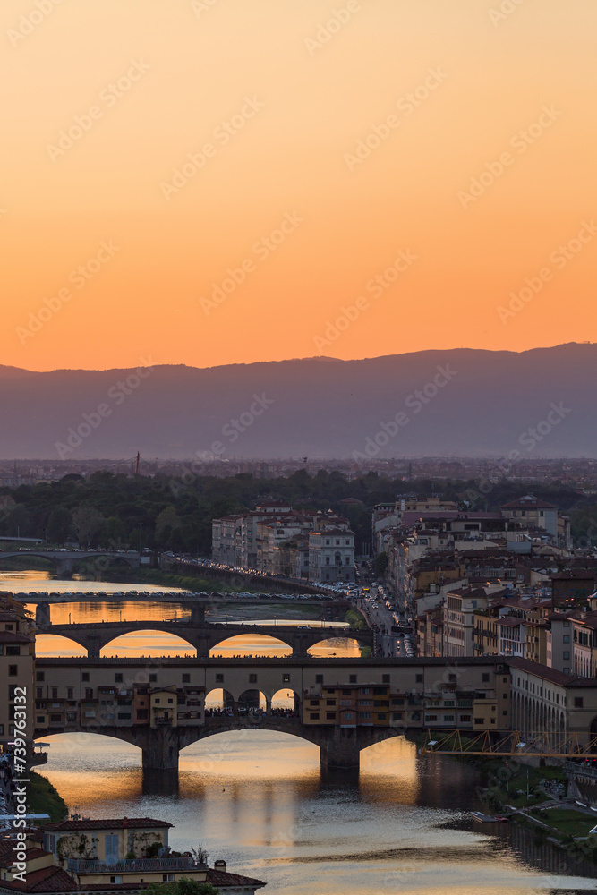 Sunset at Florence skyline with Ponte vecchio arch bridge