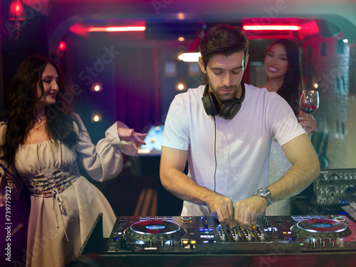 Male DJ playing music in club . Nightlife and disco concept.