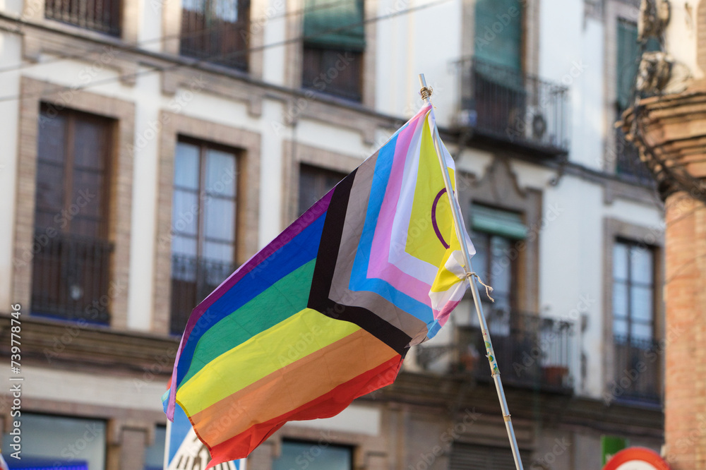 Progressive gay flag during the demonstration for gay and LGBTQ rights in the city of Seville, Spain. Concept of equality and gay rights.