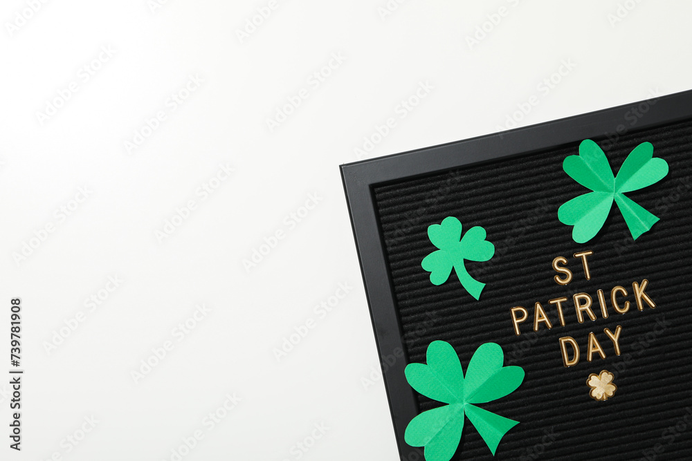 Black letters board with golden letters and paper clover leaf on white background, space for text Black letters board with golden letters and paper clover leaf on white background, space for text
