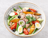 salad with tuna, quail egg and olives studio food photo 5