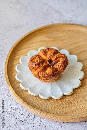 Kouign-amann is a sweet Breton cake made with laminated dough. It is a round multi-layered cake, originally made with bread dough, containing layers of butter and incorporated sugar