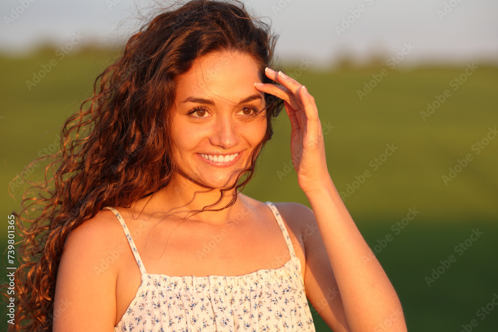 Happy beauty woman at sunset in nature contemplating