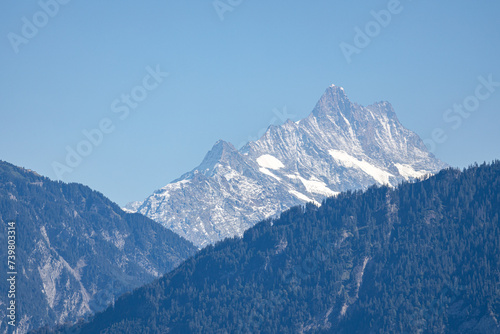 snow covered mountains under blue sky in sunshine