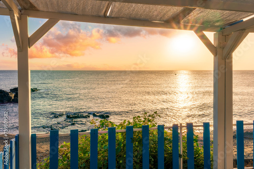 amazing view from a balcony of hotel to a nice sea gulf with beautiful sunrise or sunset  rocks and water with waves.