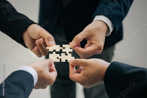 Concept of teamwork and partnership. Hands of business people join puzzle pieces together in the office. Charity, volunteer. Unity, team business. success and strategy. togetherness Collaboration.