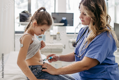 Nurse injecting insulin in diabetic girl belly. Close up of young girl with type 1 diabetes taking insuling with syringe needle.