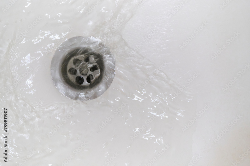 Swirl of water flows down the drain in the bathroom. Stock Photo ...