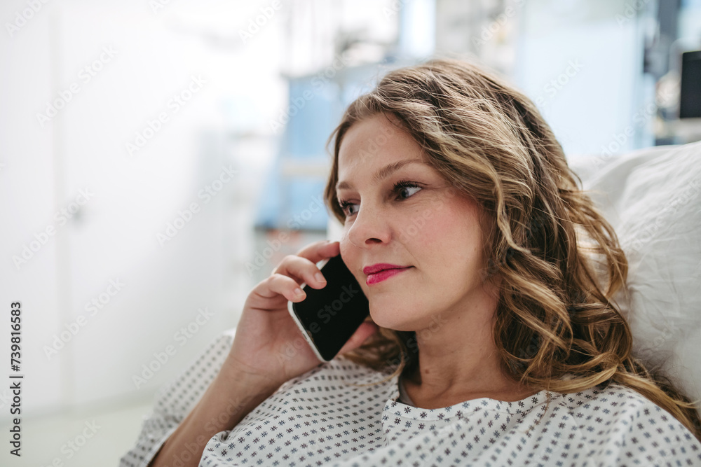 Woman phone calling from hospital room after successful surgery. Emotional support from family for patients in hospital. Woman phone calling from hospital room after successful surgery. Emotional support from family for patients in hospital.