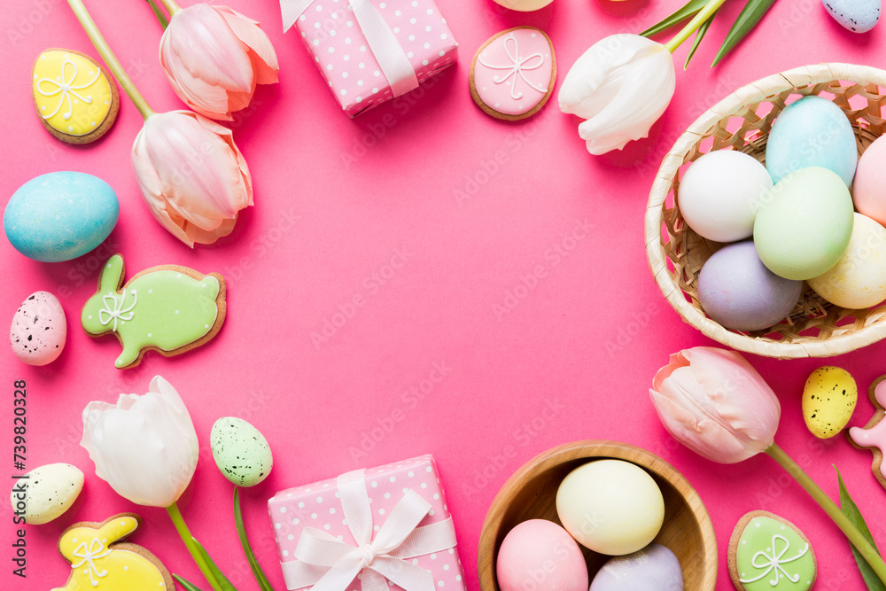 Easter frame with eggs, gift box and tulip on a colored background. The minimal concept. Top view Happy Easter composition. Card with a copy space of the place for the text Easter frame with eggs, gift box and tulip on a colored background. The minimal concept. Top view Happy Easter composition. Card with a copy space of the place for the text