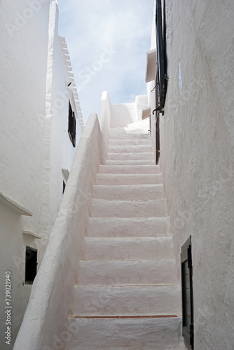 Exterior Spanish architecture and building design of The quaint old fishing village of Binibeca Vell (Binibèquer Vell), white houses form a small labyrinth of narrow, cobbled corridors- Menorca, Spain photo