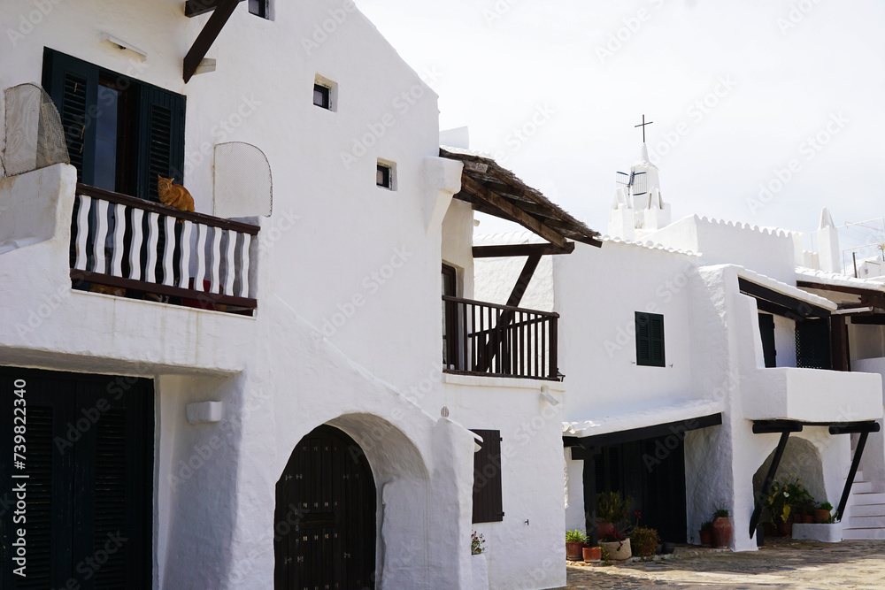 Exterior Spanish architecture and building design of The quaint old fishing village of Binibeca Vell (Binibèquer Vell), white houses form a small labyrinth of narrow, cobbled corridors- Menorca, Spain