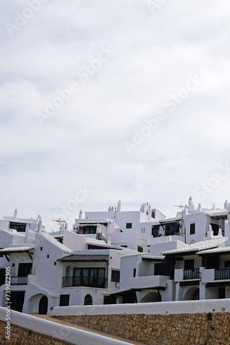 Exterior Spanish architecture and building design of The quaint old fishing village of Binibeca Vell (Binibèquer Vell), white houses form a small labyrinth of narrow, cobbled corridors- Menorca, Spain photo