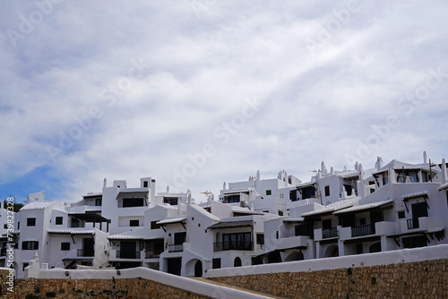 Exterior Spanish architecture and building design of The quaint old fishing village of Binibeca Vell (Binibèquer Vell), white houses form a small labyrinth of narrow, cobbled corridors- Menorca, Spain © chettarin