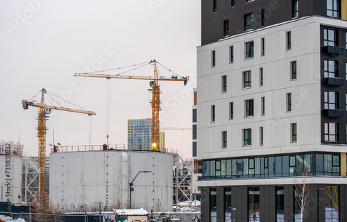 Tower cranes on the construction of new houses.