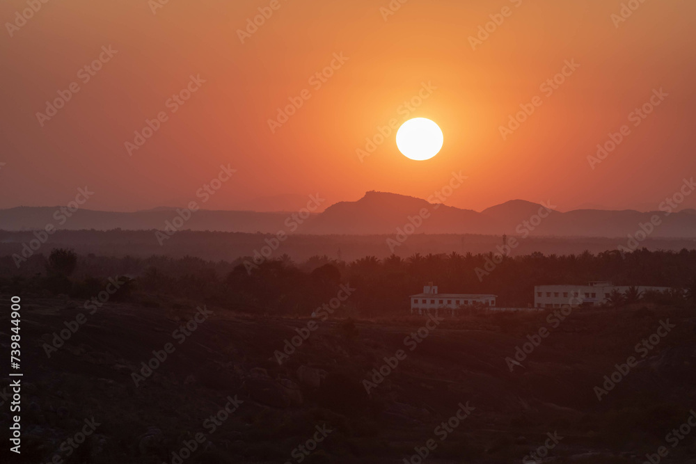 Serene Sunset Over a Tranquil Landscape With Silhouetted Mountains