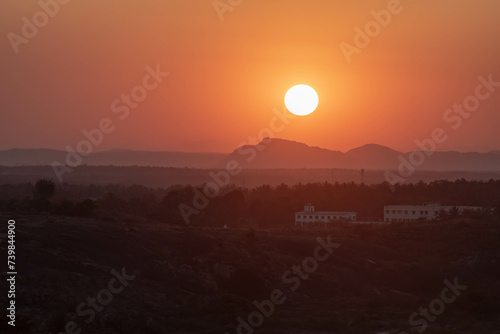 Serene Sunset Over a Tranquil Landscape With Silhouetted Mountains