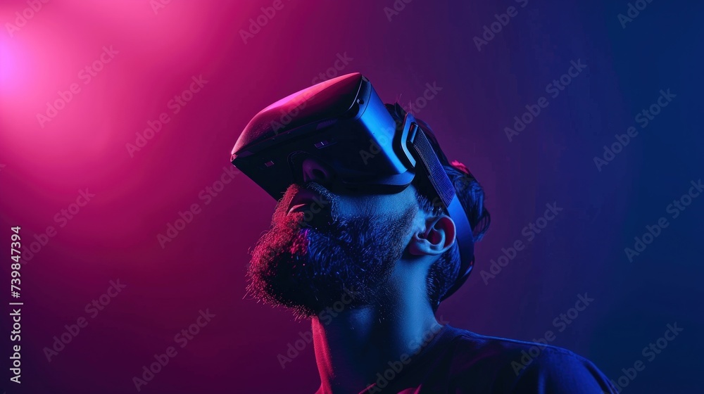 A man, a guy sits on a bright background wearing VR glasses and smiles. Advertising background with copy space, concept of virtual reality, games, training.