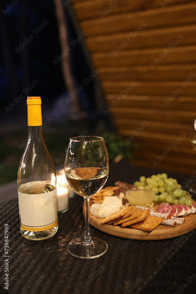 a picnic with wine in the evening on the terrace. romantic dinner with candles and wine