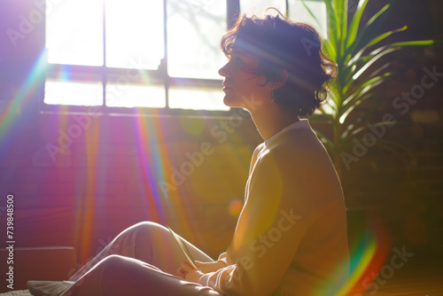  Serene Woman in Meditation with Sunlight Casting Colorful Flares