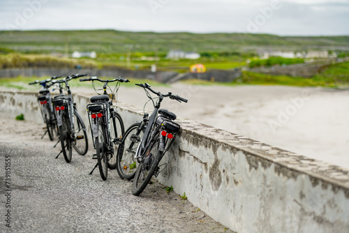 Electric bikes parked on Inishmore, the largest of the Aran Islands in Galway Bay. Renting a bicycle is one of the most popular way to get around Inis Mor, Ireland. photo