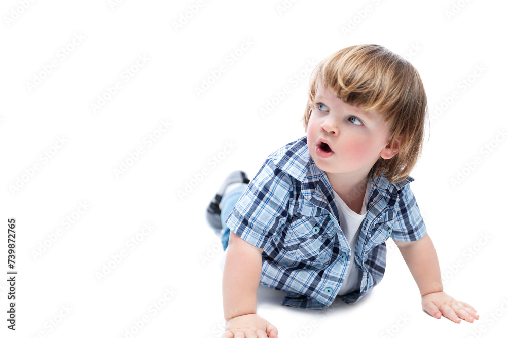 A little boy on all fours looks up in surprise. A child with a fashionable haircut wearing a blue checkered shirt and jeans. Curiosity and spontaneity. Isolated on a white background. Space for text. A little boy on all fours looks up in surprise. A child with a fashionable haircut wearing a blue checkered shirt and jeans. Curiosity and spontaneity. Isolated on a white background. Space for text.