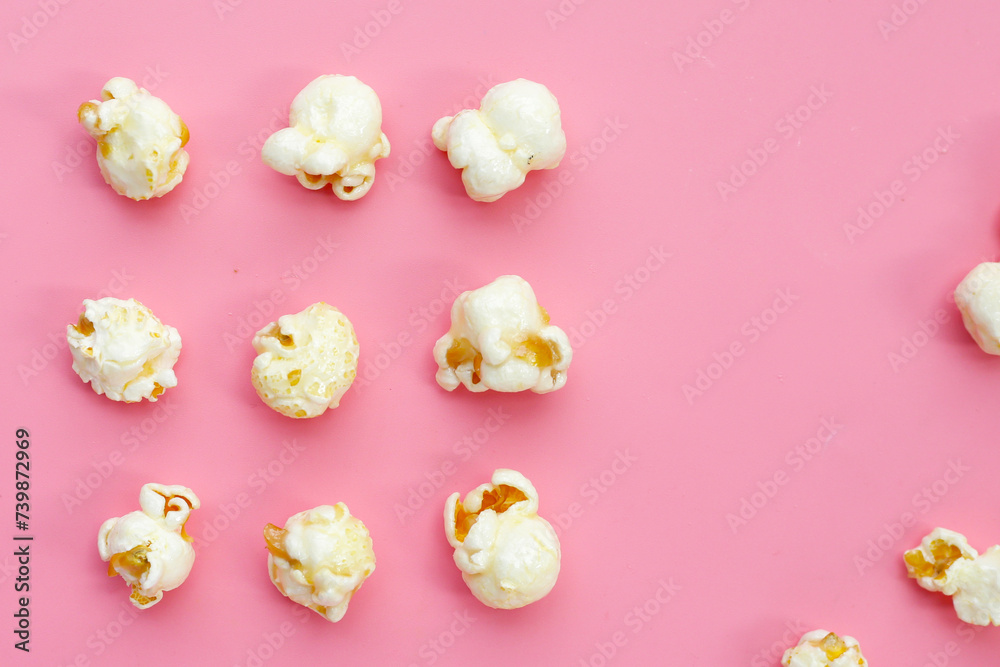 Sweet popcorn on pink background.