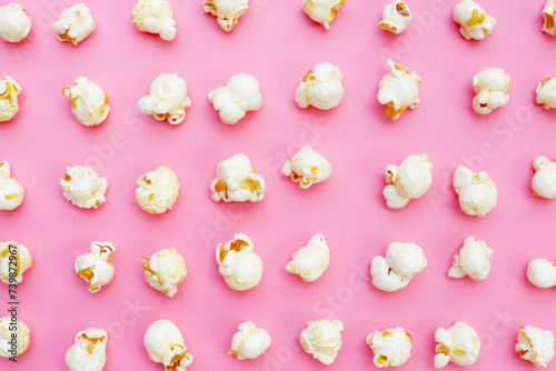 Sweet popcorn on pink background.