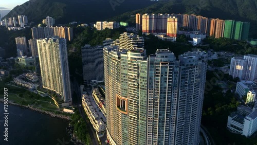 High-rise residential building (Bel Air) in Cyberport, Hong Kong during sunset time. Aerial orbit top down. photo