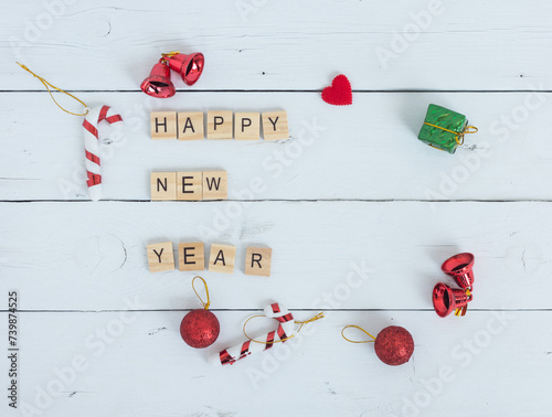 Happy new year text on white wood background.