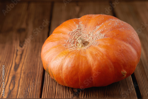 Fresh pumpkin fruit on a wooden background. Low angle view. One object.