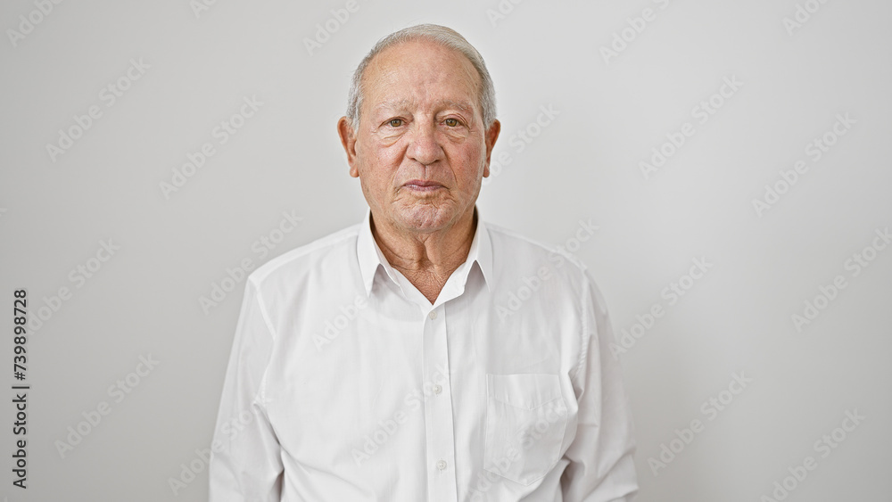 Senior man standing with serious face over isolated white background Senior man standing with serious face over isolated white background