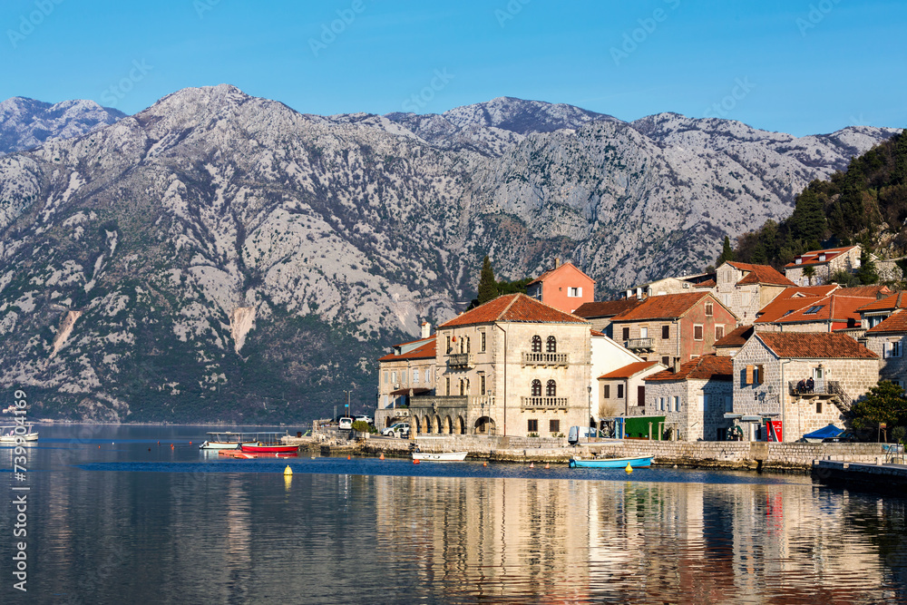 Perast. Panorama view of the historic town at famous Bay of Kotor with boats in early morning. Mountains at background. Perast, Boka Kotorska, Montenegro
