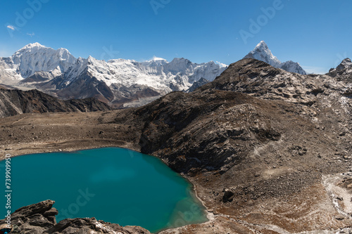 Alpine lake, Baruntsee, Ama Dablam mounts, Chukhung glacier on descent from Kongma La Pass during Everest Base Camp EBC or Three Passes trekking in Khumjung, Nepal. Highest mountains in the world. photo