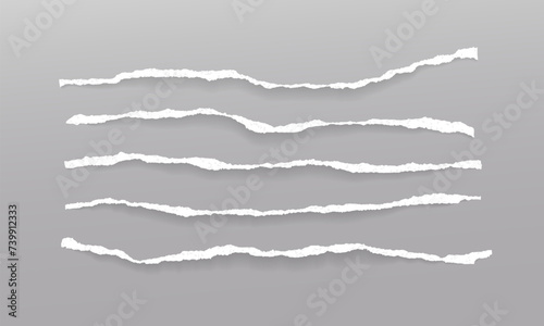 Set of torn, ripped pieces of white paper with soft shadow are on grey background for text or ad.
