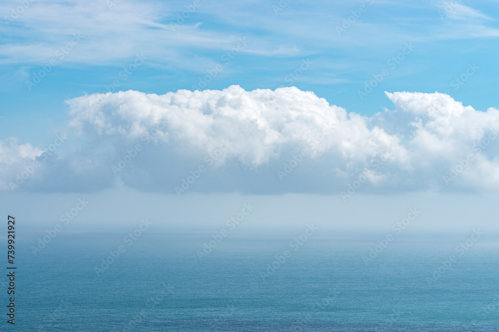 Naklejka premium View of blue sea with dramatic cloudy sky.