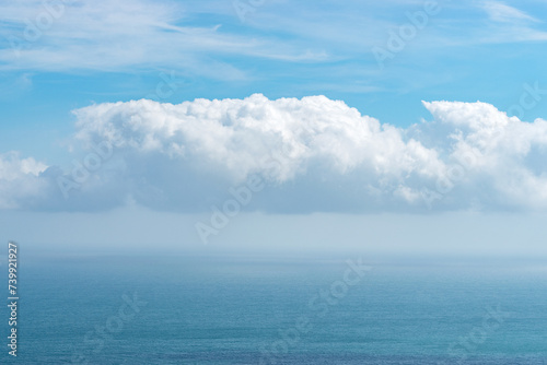 View of blue sea with dramatic cloudy sky.